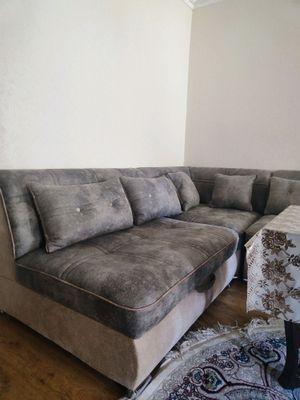 Yangi holatdagi burchak divan va stol.